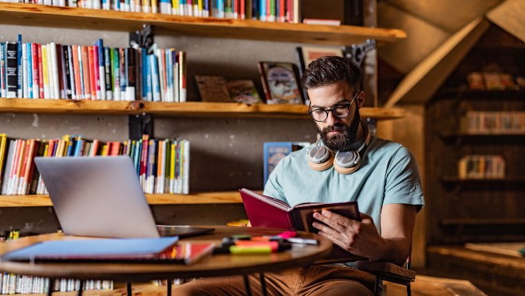 Man reading book in the library.
