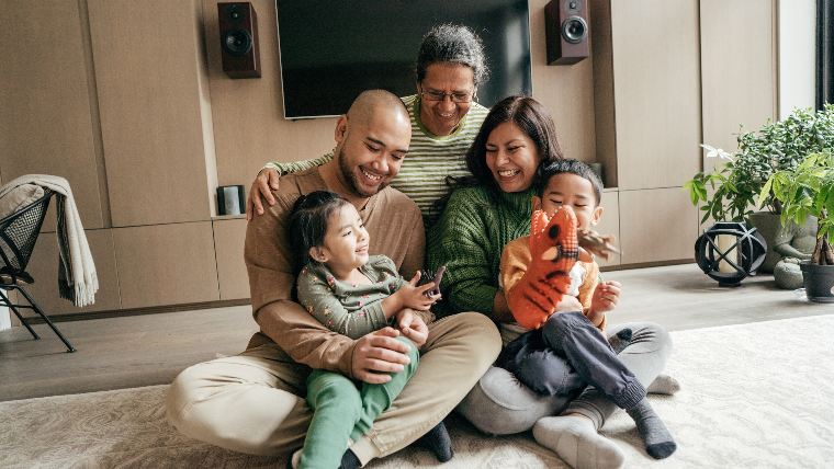 Three generations of immigrant family sitting together.