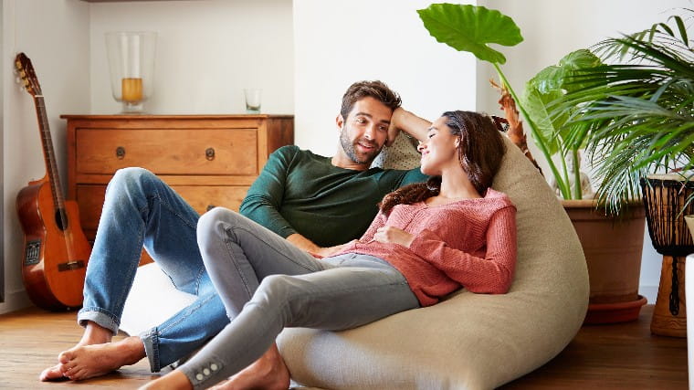 Couple having a conversation in living room.