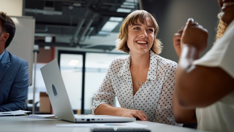 Professional woman smiling during work meeting.