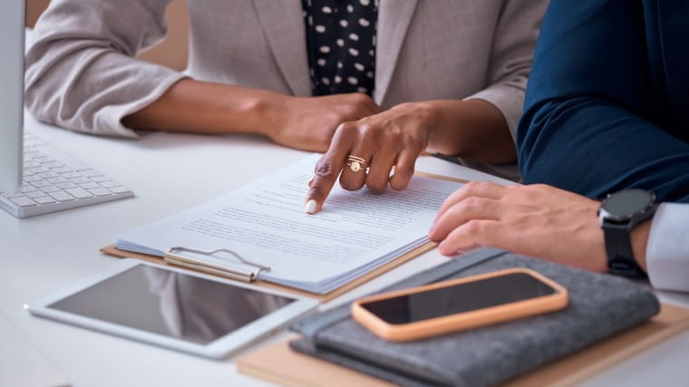Attorney and client reviewing paperwork.