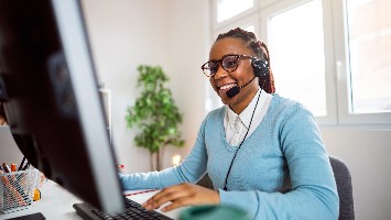 Financial counselor wearing a headset and talking to a client.