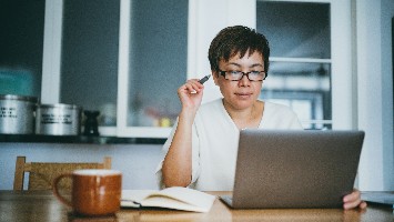 Woman reviewing information on her laptop.