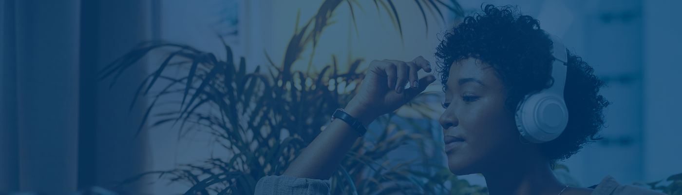 Woman listening through headphones.