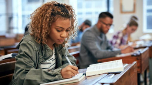 Young college student studying in the library