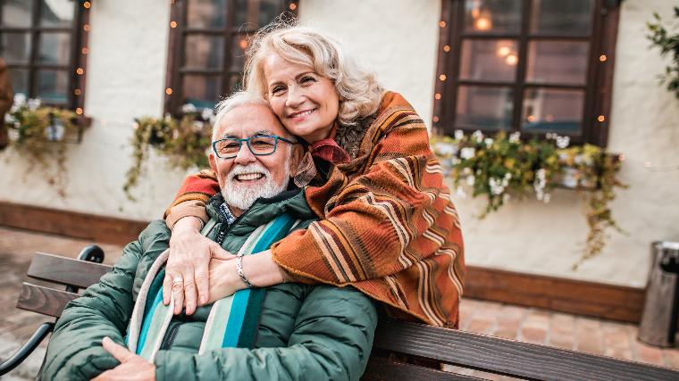 Senior couple hugging.