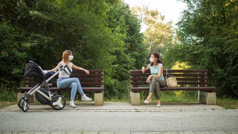 two mothers having a socially distanced conversation