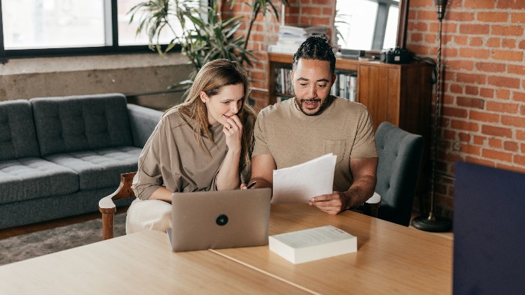 Couple reviewing loan offers online.