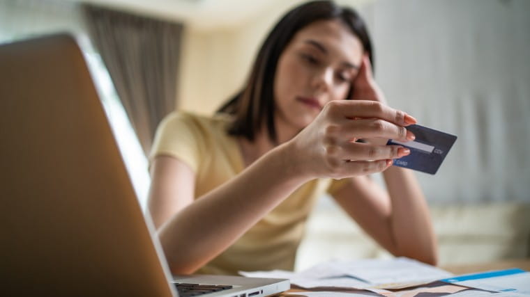 Woman examining a credit card.