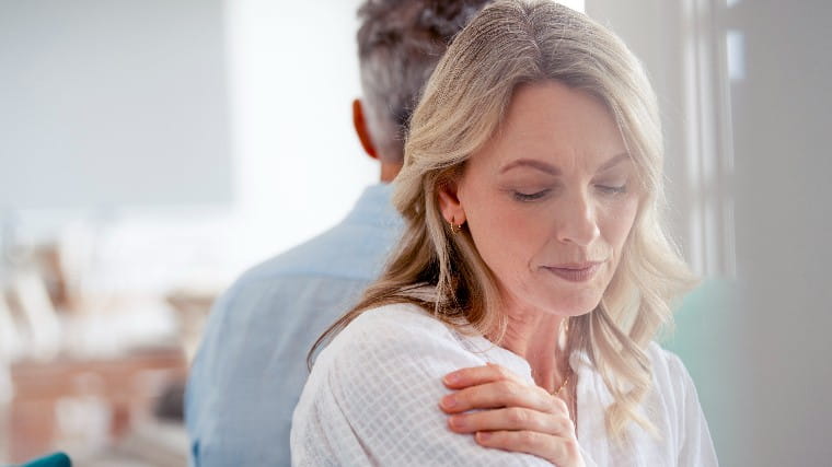 Mature woman with her back turned to her husband.