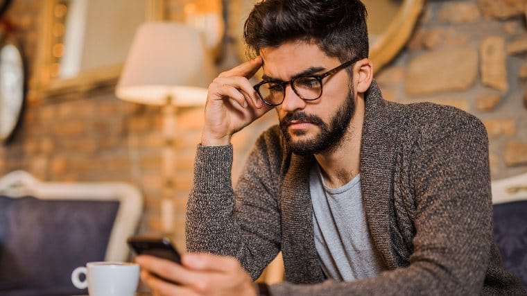 Man reading bad news on his phone.