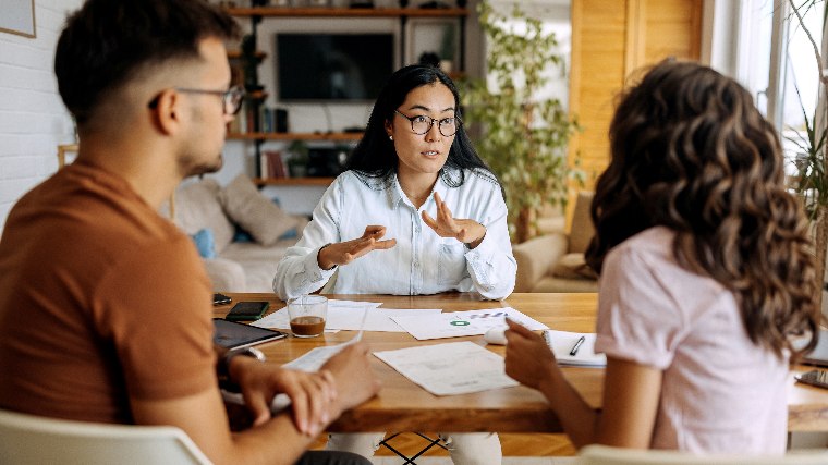 Young couple speaking with financial advisor.