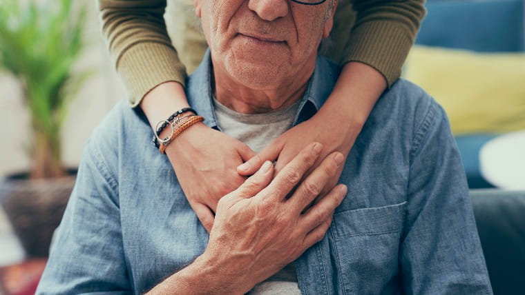 Young person hugging senior.