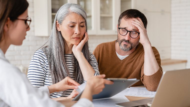 Unhappy couple consulting with attorney.