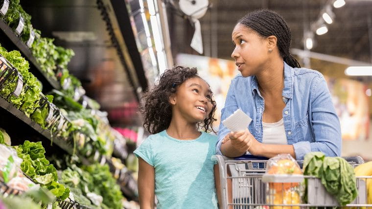 Mother and daughter grocery shopping.