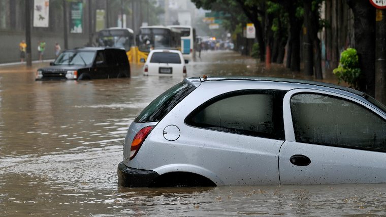 Flooded street with multiple submerged cars.