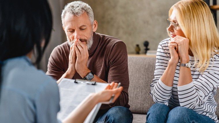 Mature couple having discussion with lawyer.
