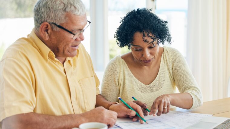 Senior couple reviewing paperwork together.