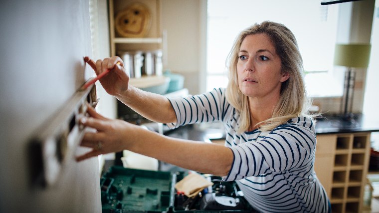 Woman working on renovations to her home.