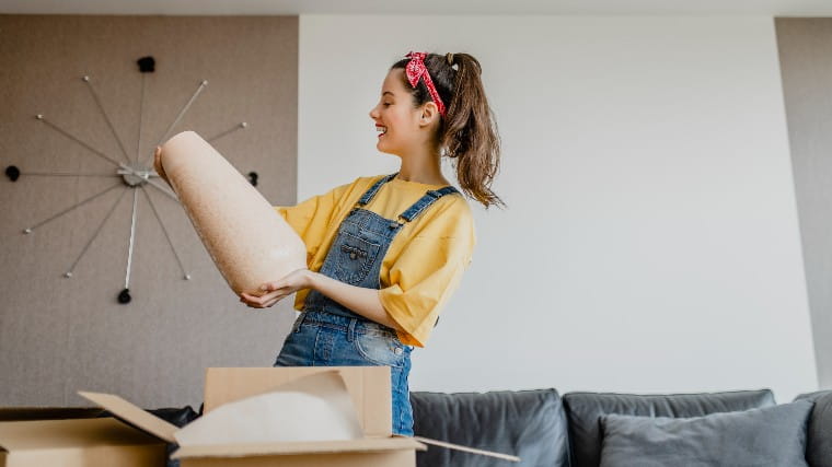 Young woman admiring her new vase.