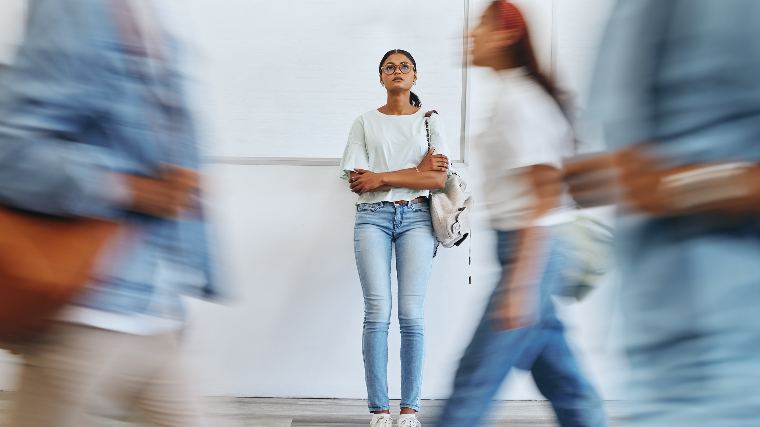 Worried woman standing in crowd.