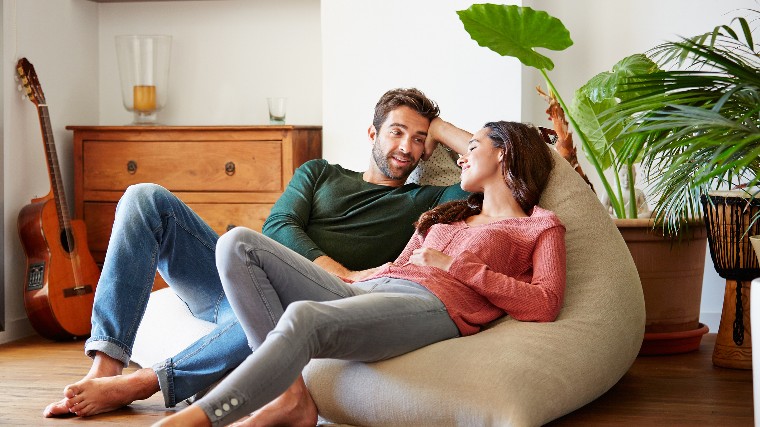 Couple having a conversation in living room.