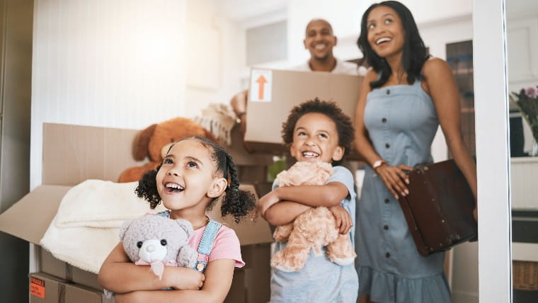 Excited young family moving into new home.