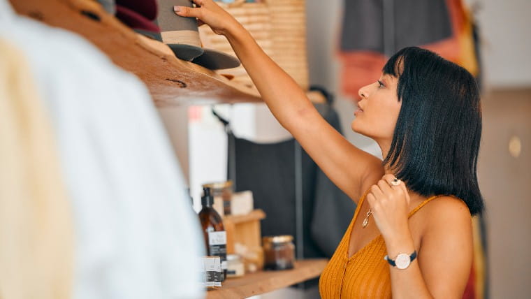 Woman shopping in designer clothing store.