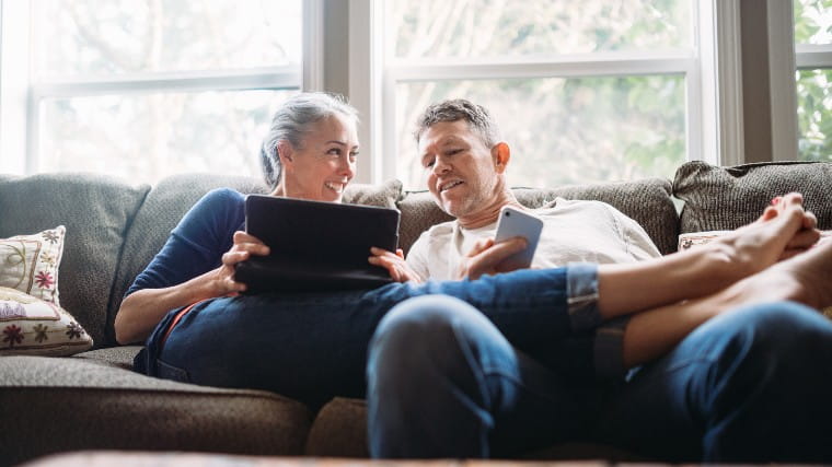 Middle age couple sitting together on couch.