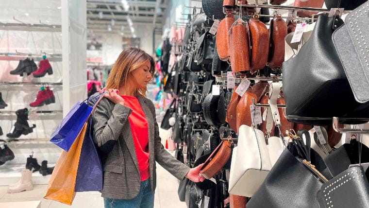 Woman shopping for handbags.