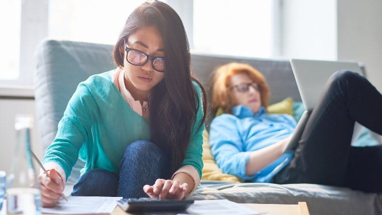 Two young woman working on their taxes.