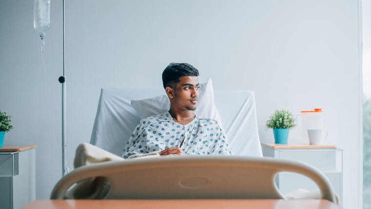 Young man in hospital bed.