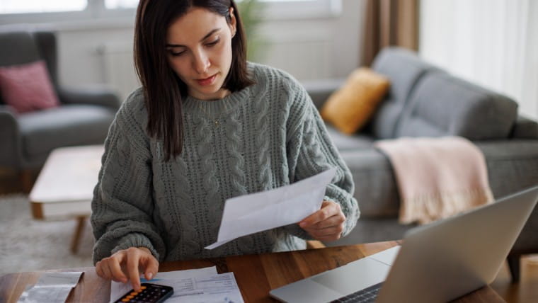 Woman reviewing financial documents.