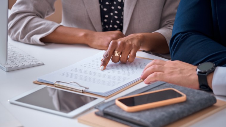Attorney and client reviewing paperwork.