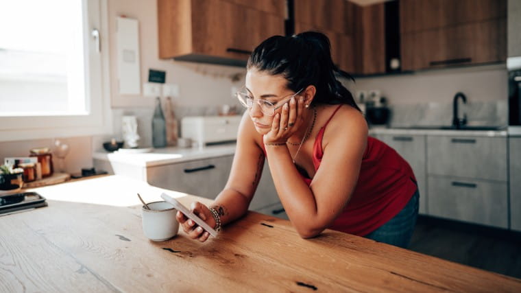 Stressed young woman checking her phone.