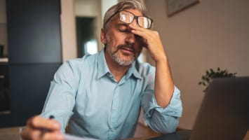 Middle aged man looking stressed out.