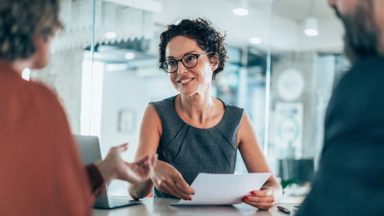 Professional woman consulting with two people.
