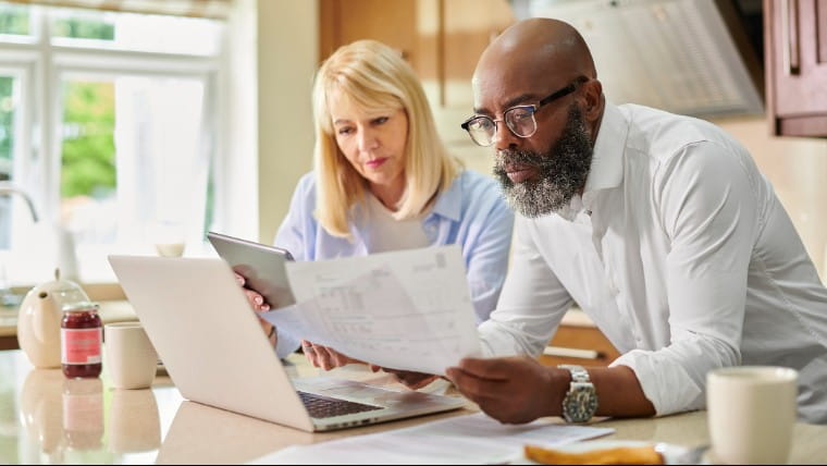 Senior couple reviewing bills together.