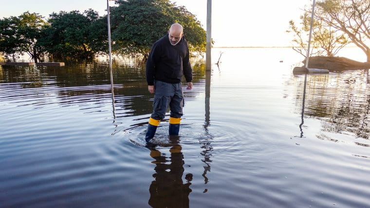 Man standing in flood water.