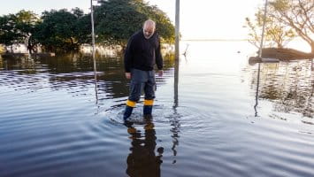 Man standing in flood water.