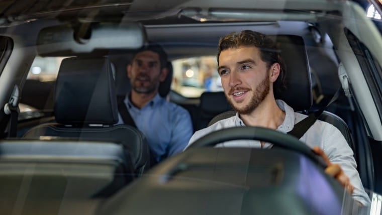 Young rideshare driver with rider.