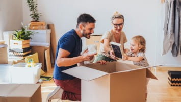 Young family unpacking in new house.