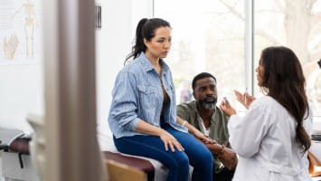 Woman consulting with doctor.
