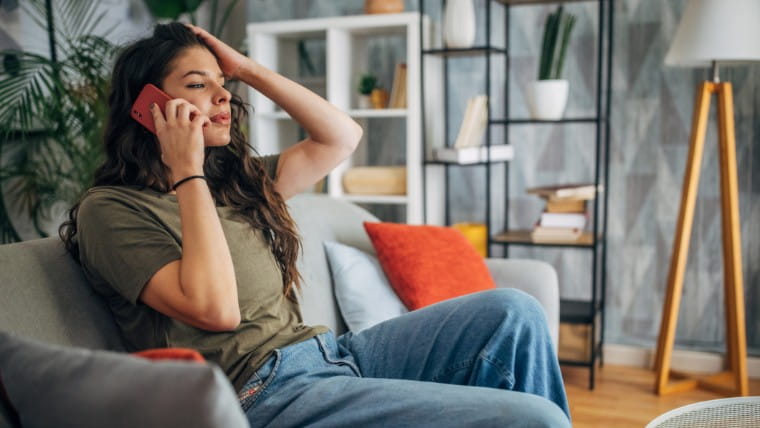 Stressed young woman talking on phone.