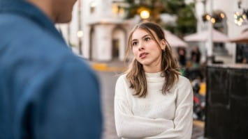 Young woman having tough conversation with partner.