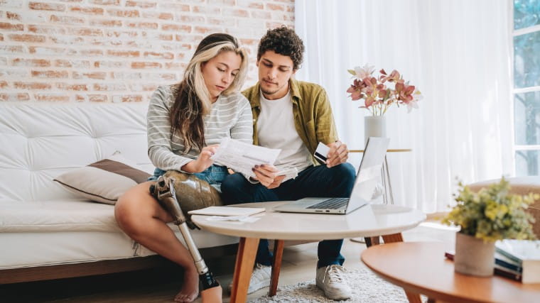 Young couple working on taxes together.
