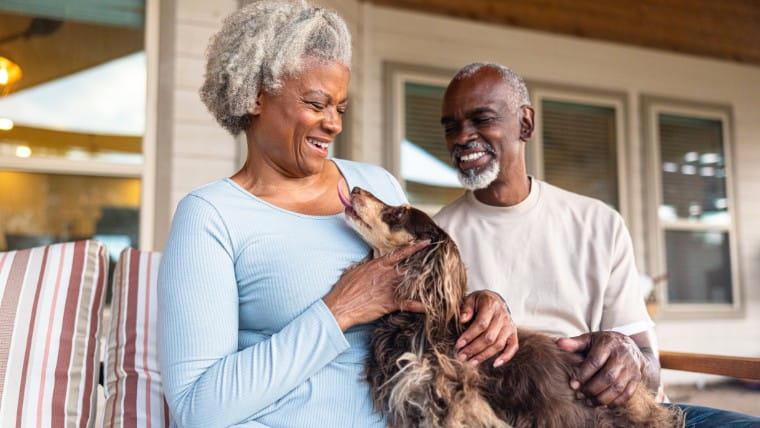 Senior couple sitting with their dog.