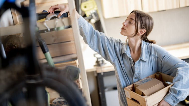 Woman cleaning garage.