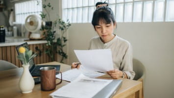 Woman reading paperwork.