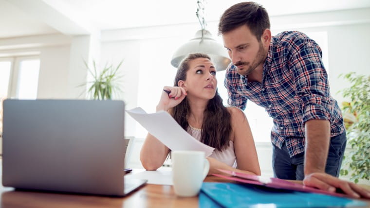 Couple reviewing financial documents.